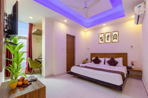 a bedroom with a bed with a blue ceiling at Hotel Ganga Ashoka-Stay By The Ganges At Triveni Ghat in Rishīkesh
