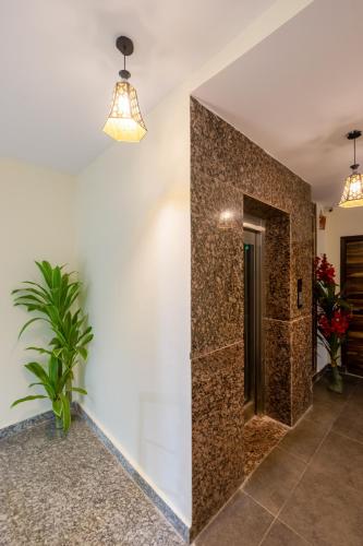 a bathroom with a mirror on the wall at Hotel Ganga Ashoka-Stay By The Ganges At Triveni Ghat in Rishīkesh