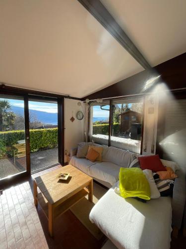 a living room with a couch and a table at Sunclass Tignale Bungalow Gardasee in Tignale