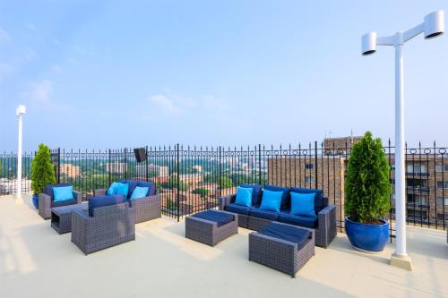 a row of blue chairs sitting on a roof at The Bethesdan Hotel, Tapestry Collection by Hilton in Bethesda