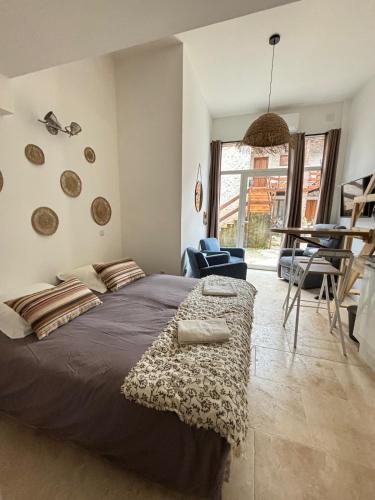 a bedroom with a large bed and a chair at Les Capucins de Provins Studio in Provins