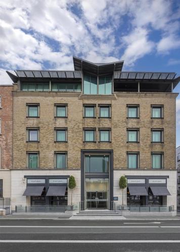 a large brick building with windows on a street at The Morrison Dublin, Curio Collection by Hilton in Dublin