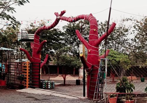a sculpture of two hands on a playground at Royal Resort in Indore