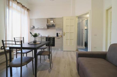 a kitchen and a living room with a table and chairs at Pompei Centro Apartments in Pompei