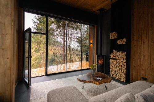 a living room with a couch and a large window at Veres Hill in Tukhlya