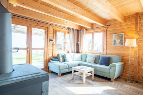 a living room with a couch and a table at Strandhus Mira in Dahme