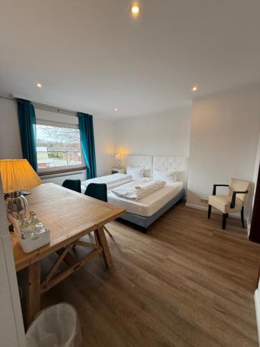 a hotel room with a bed and a table at Landhotel Franck Garni in Brietlingen
