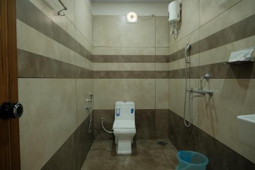 a bathroom with a toilet and a sink at The Varghese Beth in Munroe Island