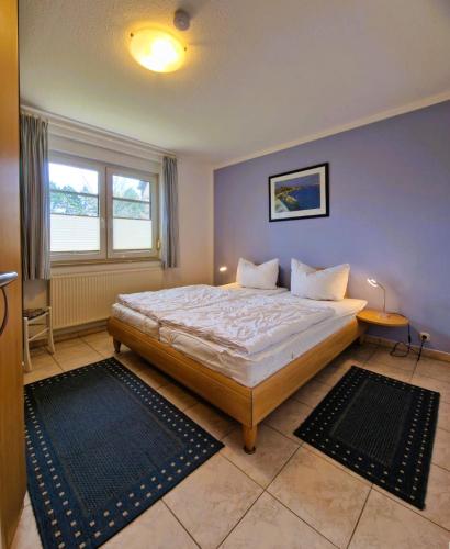 a bedroom with a bed and a large window at Neue Liebe - Wohnung 1 in Groß Kirr