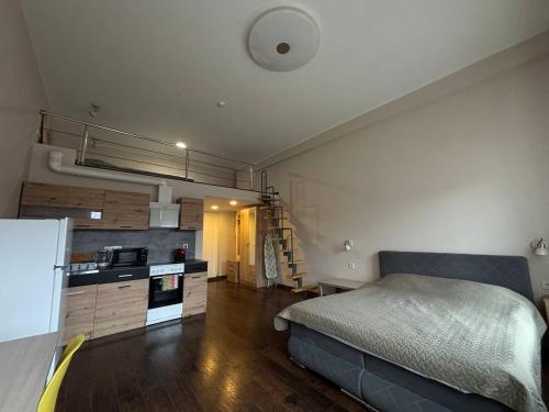 a bedroom with a bed and a kitchen in a room at Apartments near Noblessner in Tallinn