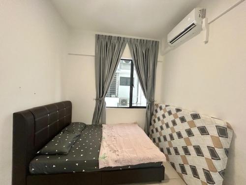 a small bedroom with a bed and a window at PeaceStay in Sandakan