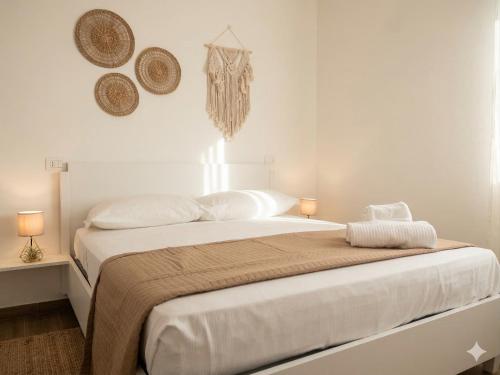a white bedroom with a large bed with two lamps at Central Suite - Premium Villas in Giulianova