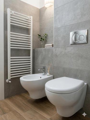 a bathroom with a white toilet and a sink at Central Suite - Premium Villas in Giulianova
