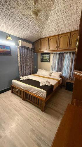 a bedroom with a large bed in a room at Thanal Home Stays in Kollam