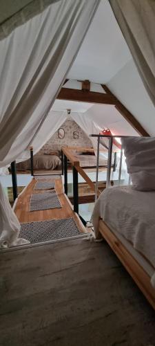 a bedroom with two beds in a tent at Maison Oscar et Petrus in Beaumont-du-Gâtinais