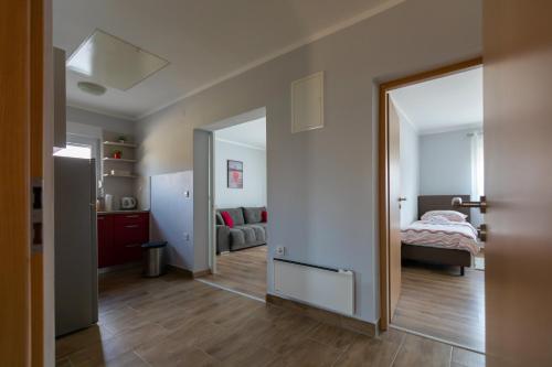a bedroom with a bed and a living room at Apartments Slavek in Jastrebarsko