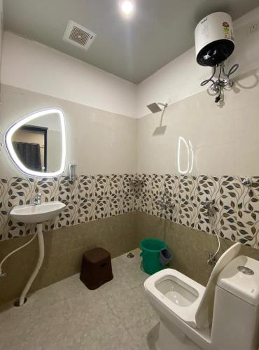a bathroom with a toilet and a sink at Rudravasa Inn in Varanasi