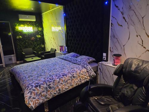 a bedroom with a bed and a chair in it at Medusa spa 34* in Montpellier
