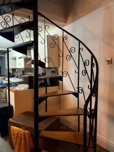 a spiral staircase in a room with a kitchen at The Dearham Lonnin Nook in Dearham