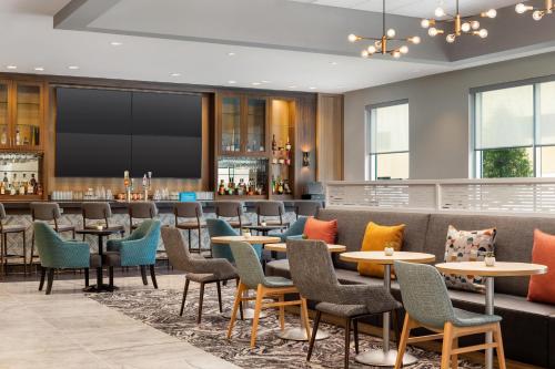 a restaurant with tables and chairs and a bar at Home2 Suites By Hilton Houston Downtown Convention Center in Houston