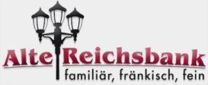 a sign for a restaurant with a street light at Alte Reichsbank in Schweinfurt