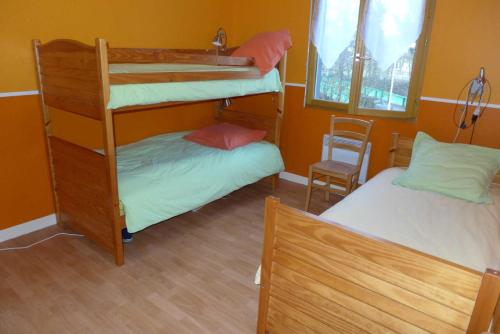 a room with two bunk beds and a chair at Valériane in Froncles