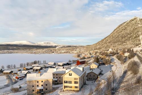 an aerial view of a village with snow covered mountains at Olen Village - Funäsdalen in Funäsdalen