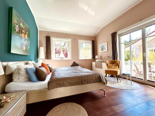 a bedroom with a bed and a couch and windows at Strandquartier 31 "Quartier 2" in Wustrow