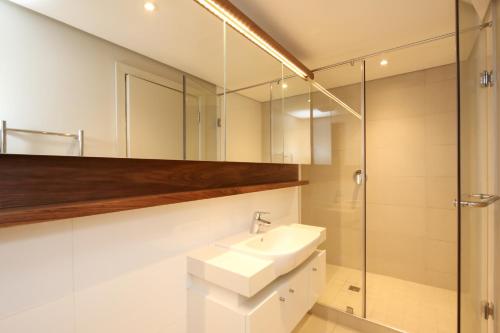 a bathroom with a sink and a shower at Zimbali Suites 223 in Ballito