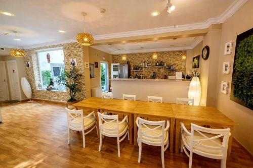 a dining room with a large wooden table and chairs at Hostal Mar del Plata in El Arenal