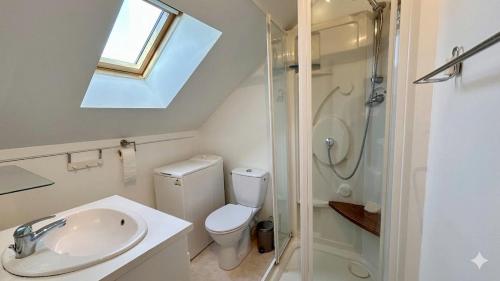 a bathroom with a sink and a toilet and a shower at Maison duplex centre plage port cabine in Le Crotoy