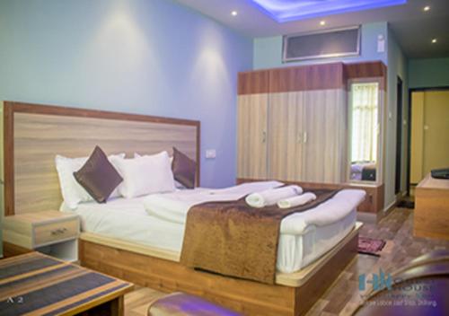 a bedroom with a large bed in a room at HN Guest House in Shillong