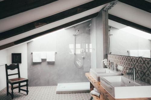 a bathroom with a shower and two sinks and a glass showeroser at Luna Mia - Apartment 5 in Schwangau
