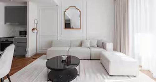 a living room with a white couch and a table at Burj Khalifa View & Creek lagoon in Dubai