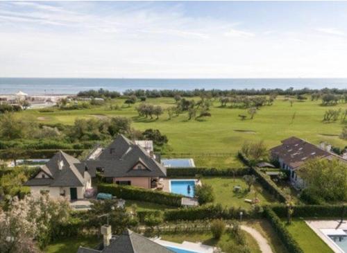 an aerial view of a house with a golf course at Villa Helena, Venetien, Exklusive Villa auf Privatinsel Albarella, 4 Bedrooms 8 Personen, 300 m Strand in Isola Albarella