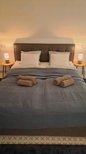 two towels on a bed with two pillows on it at MANSARD - Bozsok in Bozsok