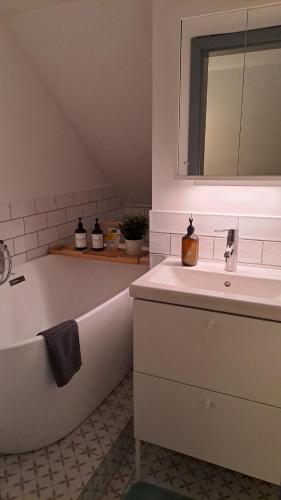 a bathroom with a sink and a bath tub at MANSARD - Bozsok in Bozsok