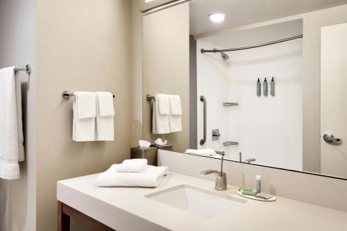 ein Badezimmer mit Waschbecken und großem Spiegel in der Unterkunft Courtyard by Marriott Ogden in Ogden
