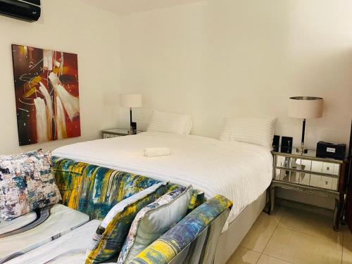 a bedroom with a large bed and a couch at Royal Lodge in Sibasa
