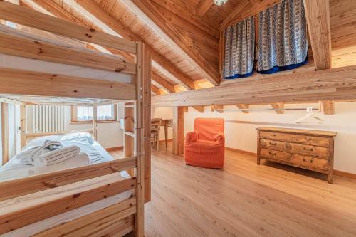 a bedroom with two bunk beds and a desk at Chalet Dolomites Heart in Feder