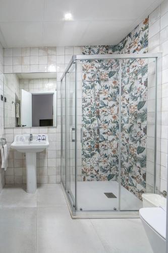 a bathroom with a shower and a sink at Lantana Garden in Pilas