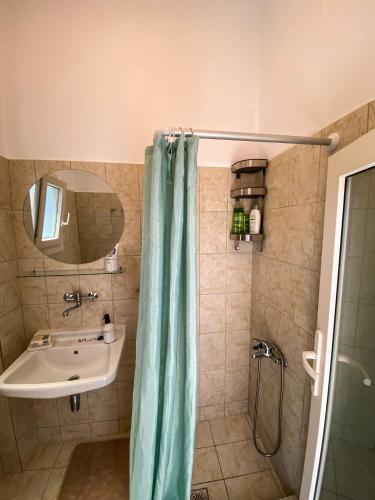 a bathroom with a sink and a shower at Gaia in Agios Georgios