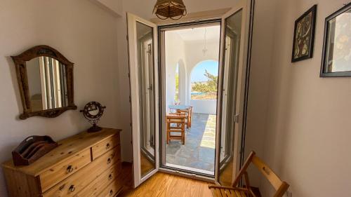 a room with a sliding glass door leading to a patio at Gaia in Agios Georgios