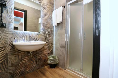 a bathroom with a sink and a shower at Buono Hotel in Naples