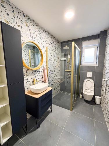 a bathroom with a sink and a shower and a toilet at New Villa Oasis in Imotski