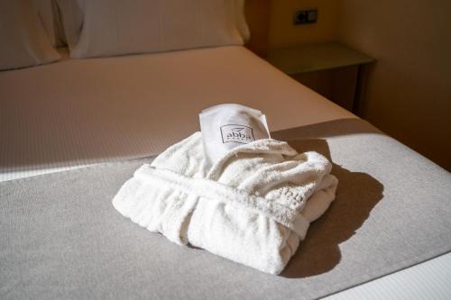 a white towel sitting on top of a bed at Abba Madrid in Madrid
