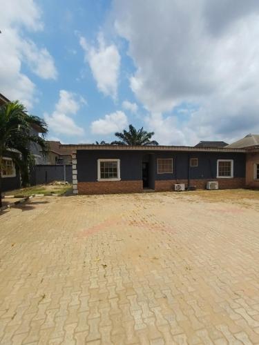 a house with a brick driveway in front of it at AP Luxury Inn in Idowu