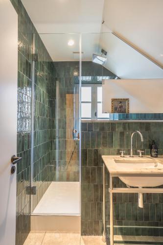 a bathroom with a sink and a shower at Manoir Des Douets Fleuris in Cancale