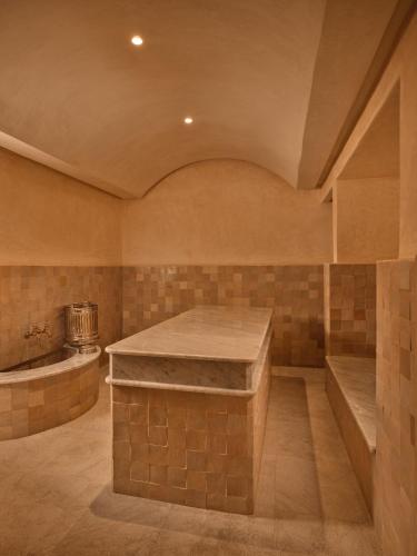 a kitchen with a stone counter and a tub at Villa Sahrai, a Member of Design Hotels in Casablanca