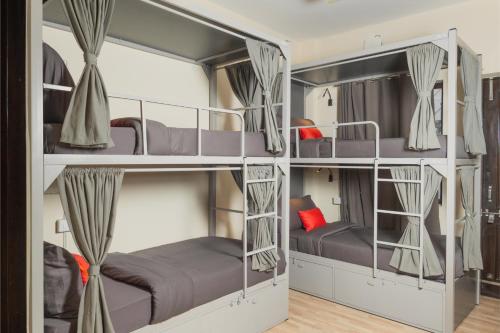 a group of bunk beds in a room at Loop by Zolo Baani Square, Gurugram in Gurgaon